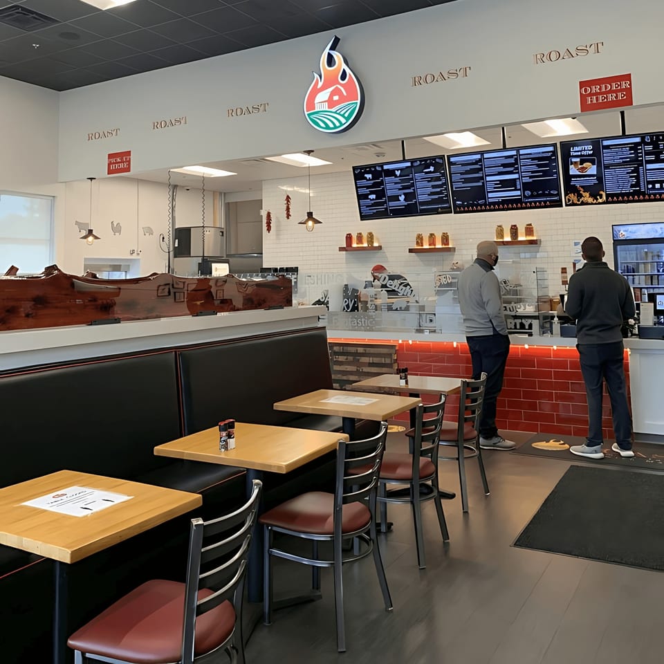 Interior of Roast restaurant with two men at the counter, tables, and booths.